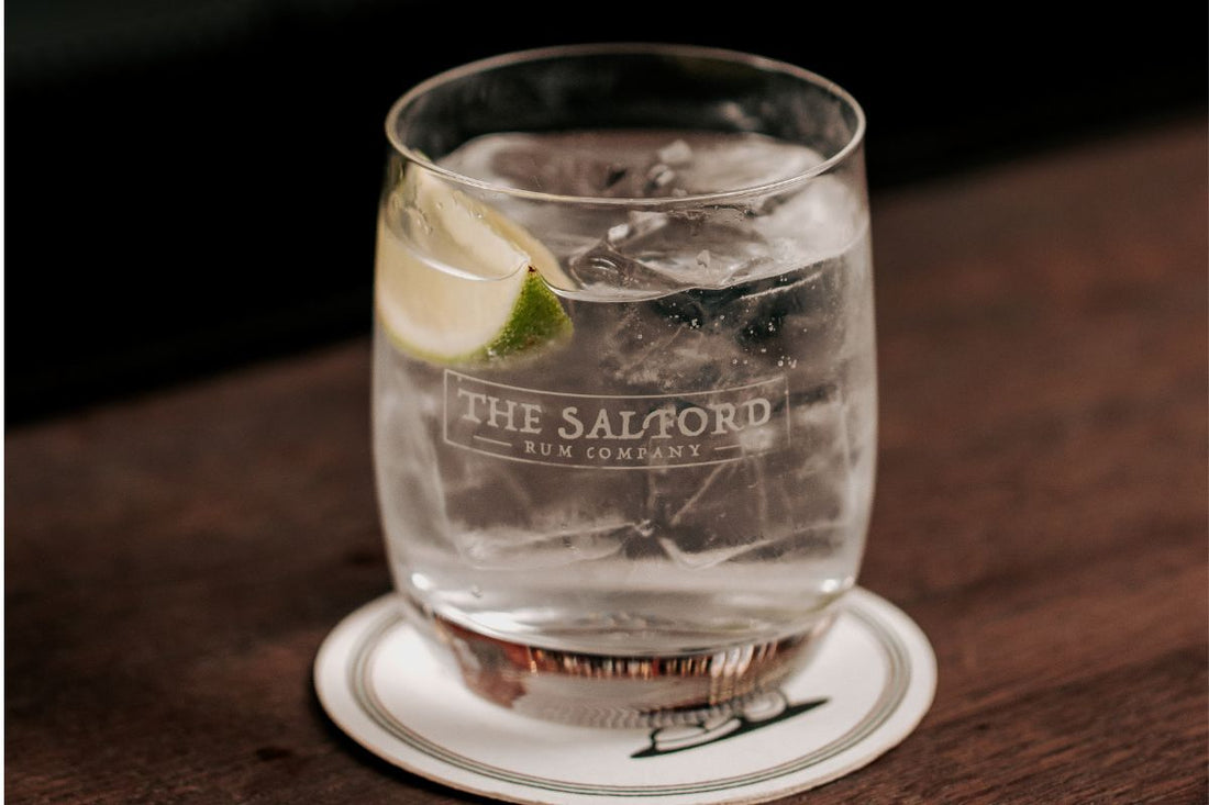 Salford Gin served as a gin and tonic with ice and lime in a branded Salford Rum Company glass
