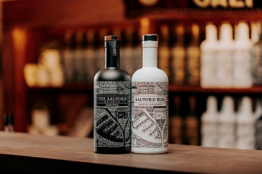 Salford Dark Spiced Rum and Original Golden Spiced Rum bottles side by side on a bar