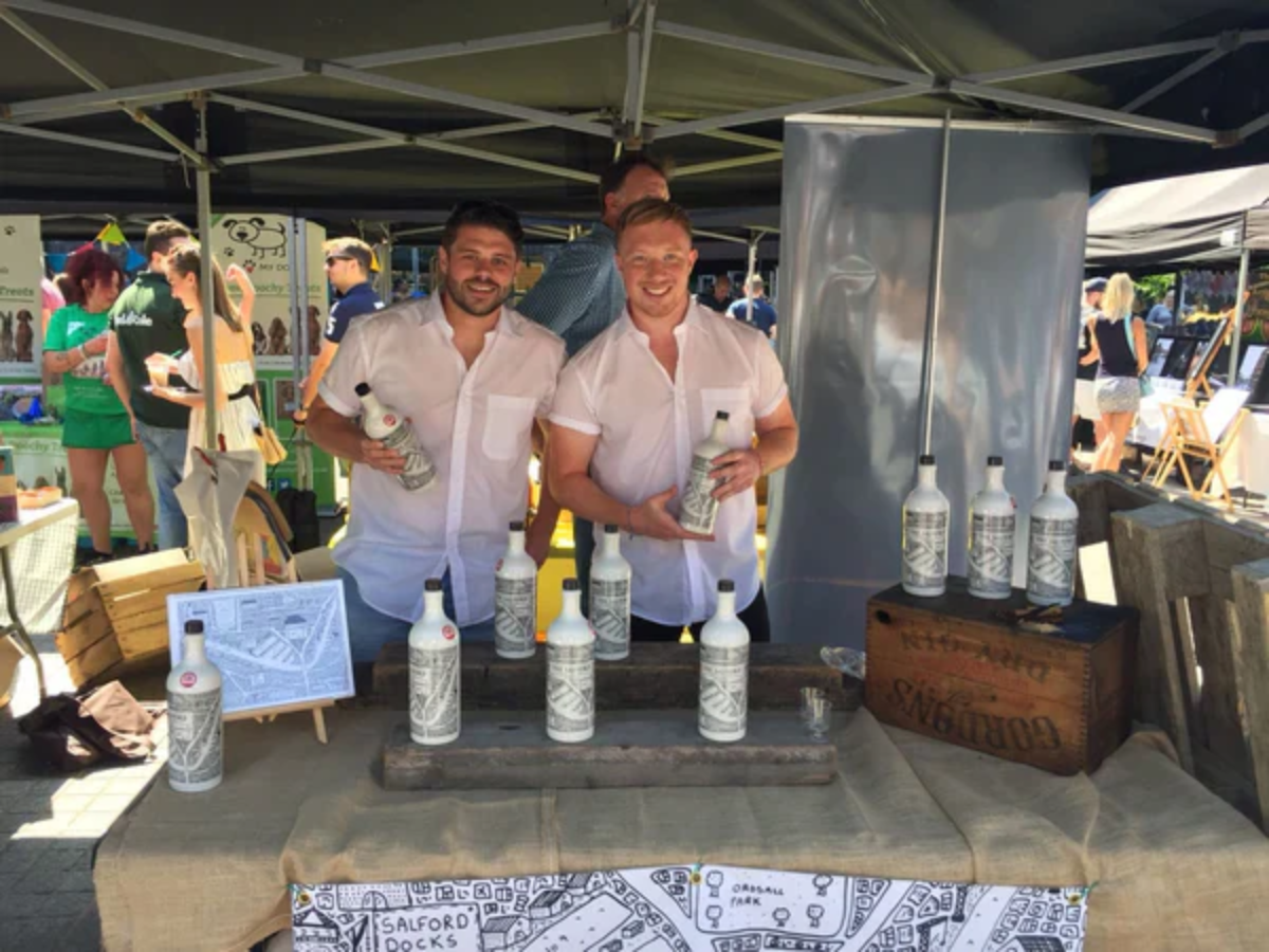 Tommy and James selling their first bottles at a local market