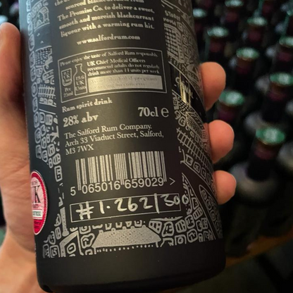 Close-up of the back label on the Rum and Black bottle showing the 28% ABV and batch number.